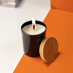 Frosted glass scented candles with bamboo lids in white and black, featuring customizable logo branding.