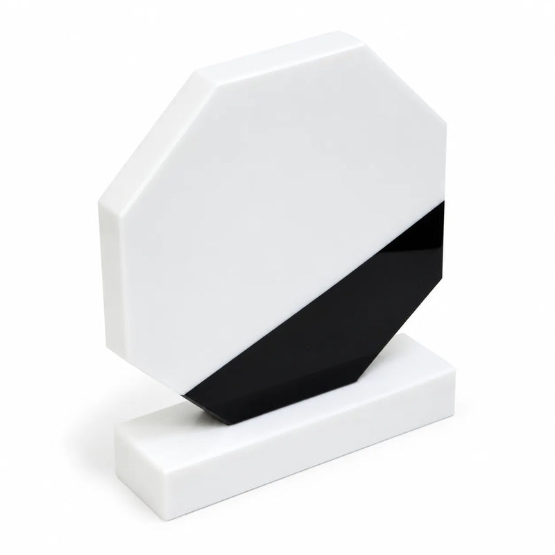 White marble octagonal crystal award on a desk