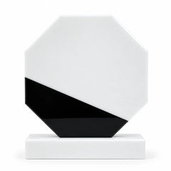 White marble octagonal crystal award on a desk