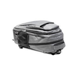 Gray travel backpack with zipper and USB charging feature
