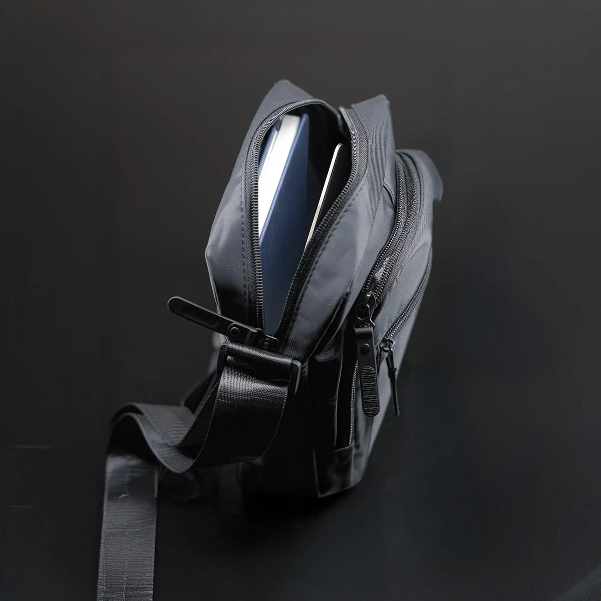 Premium black sling bag with adjustable strap and multi-compartment travel design