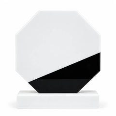 White marble octagonal crystal award on a desk