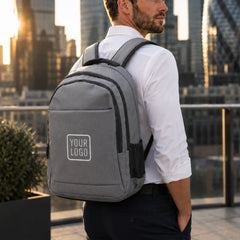 Gray travel backpack with zipper and USB charging feature