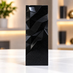 Black geometric faceted crystal award column on a desk