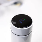 Touch LED temperature display lid close-up on white insulated bottle.