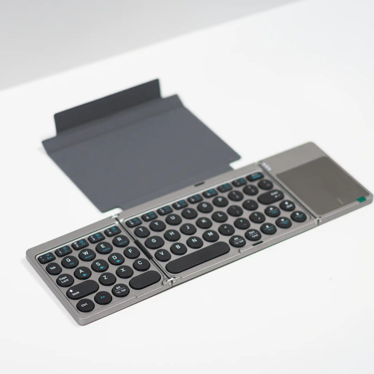 Foldable Bluetooth keyboard open flat showing the full layout and touchpad