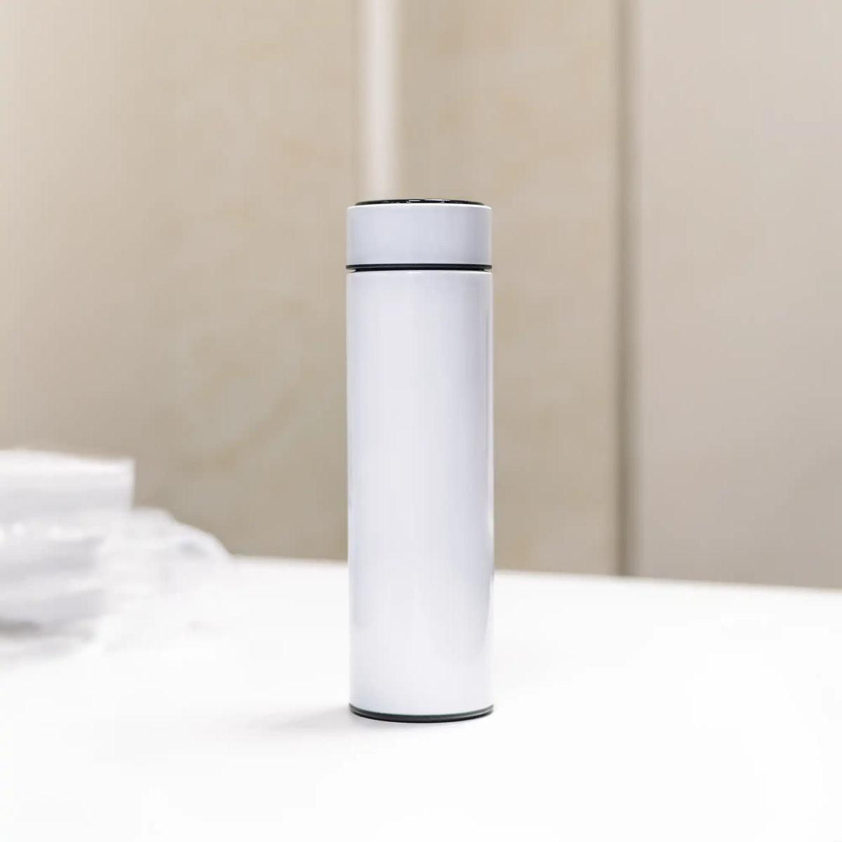 Minimal white stainless-steel smart bottle standing on table