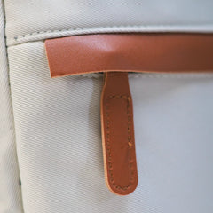 Beige Voxtra travel backpack, front three-quarter view with tan leather trim