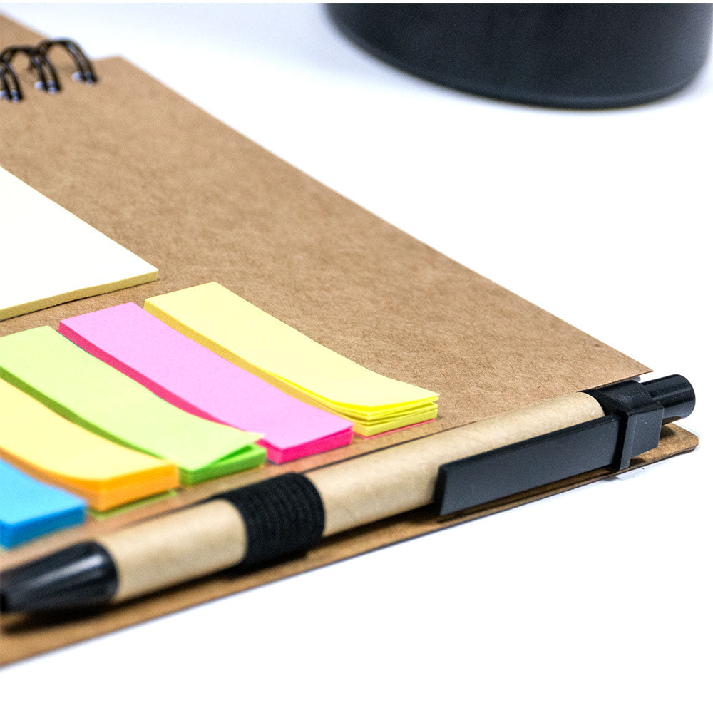 A5 notebook with a pen and sticky notes