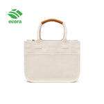 Canvo canvas tote carried by hand, shown in use at everyday scale