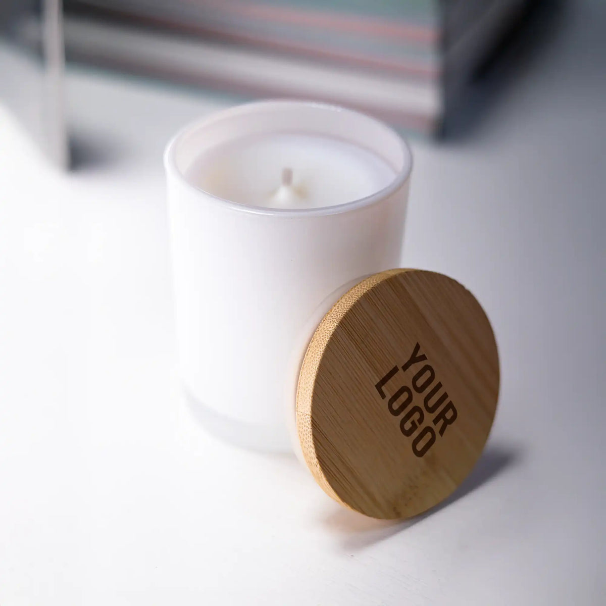 Frosted glass scented candles with bamboo lids in white and black, featuring customizable logo branding.